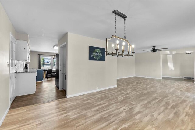 unfurnished dining area featuring light hardwood / wood-style flooring and ceiling fan