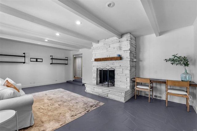 living room featuring beam ceiling and a stone fireplace