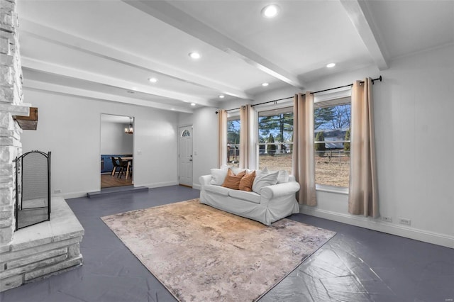 living room featuring a large fireplace and beamed ceiling