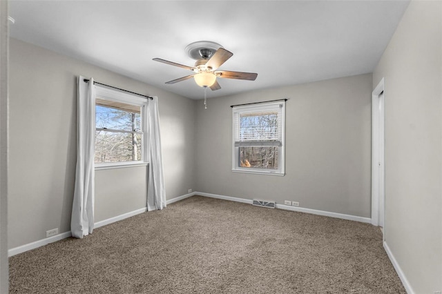 unfurnished room with ceiling fan, carpet floors, and a healthy amount of sunlight