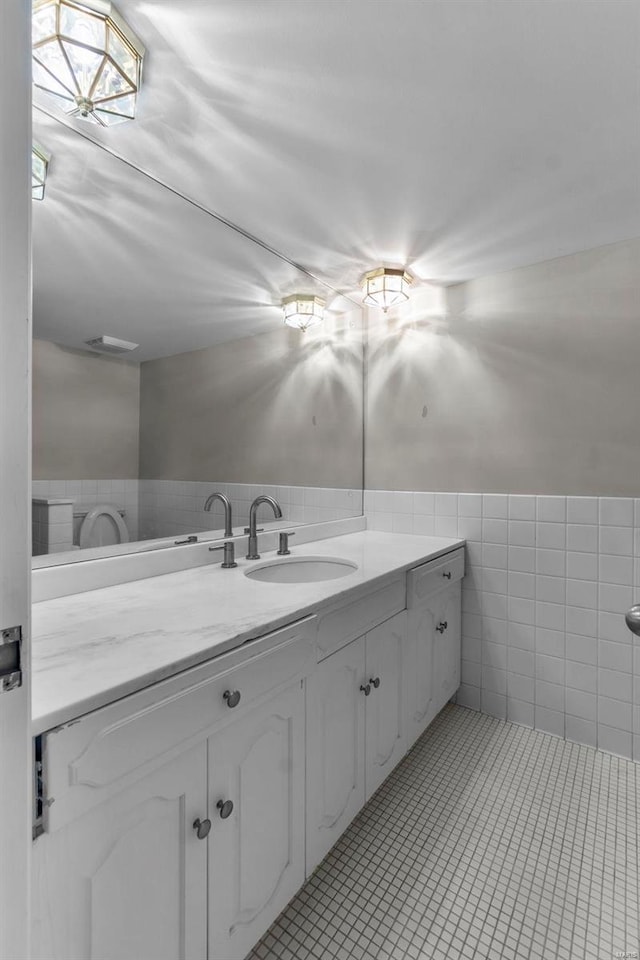 bathroom with tile patterned floors, tile walls, and vanity