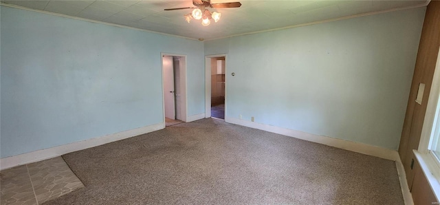 carpeted spare room featuring ceiling fan