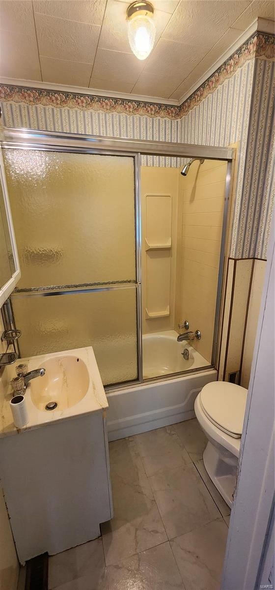 full bathroom featuring tile floors, combined bath / shower with glass door, toilet, and vanity