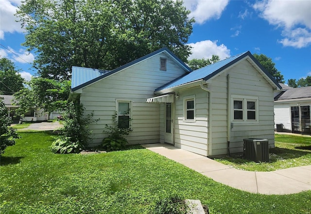 exterior space featuring a yard and central AC unit