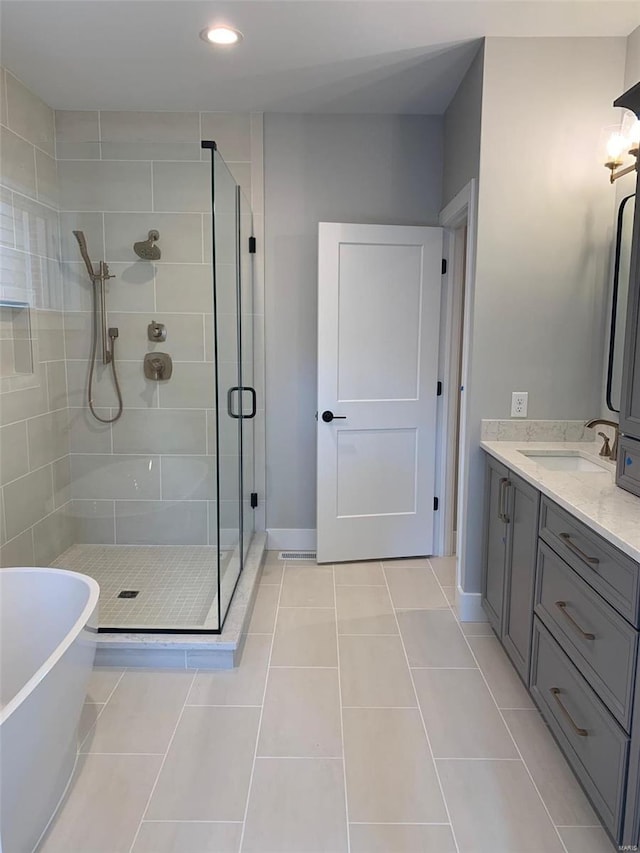 bathroom featuring vanity, tile patterned floors, and independent shower and bath