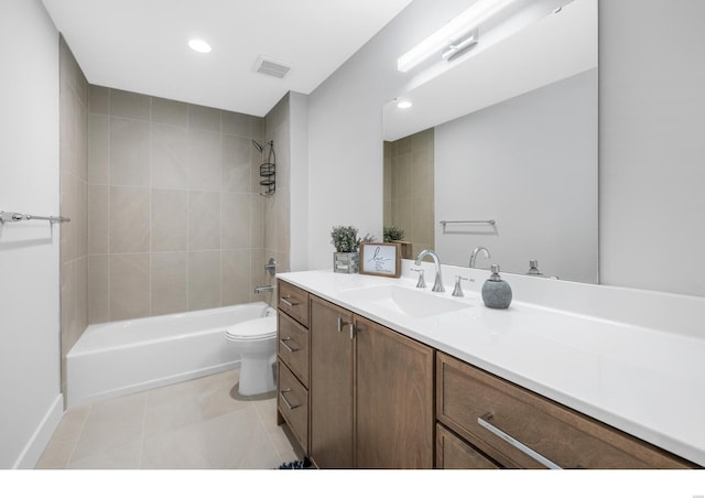 full bathroom with tile patterned flooring, vanity, toilet, and tiled shower / bath