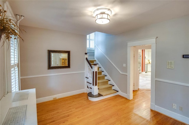 stairs with hardwood / wood-style floors