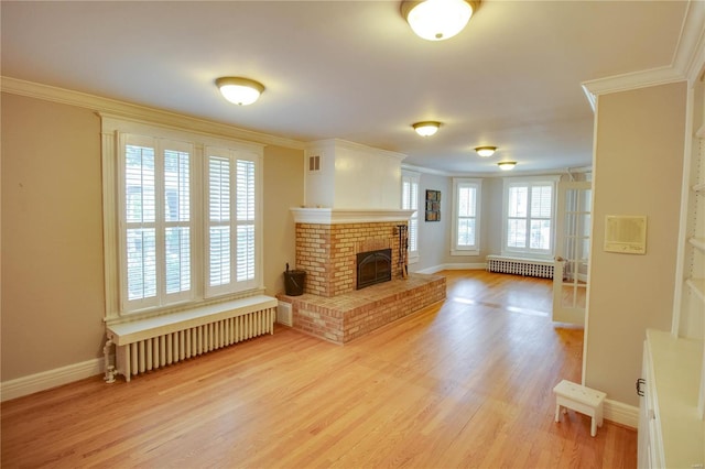 living room featuring a wealth of natural light, radiator heating unit, and ornamental molding