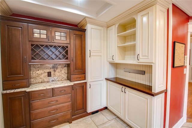 bar featuring light tile patterned flooring, light stone countertops, and backsplash