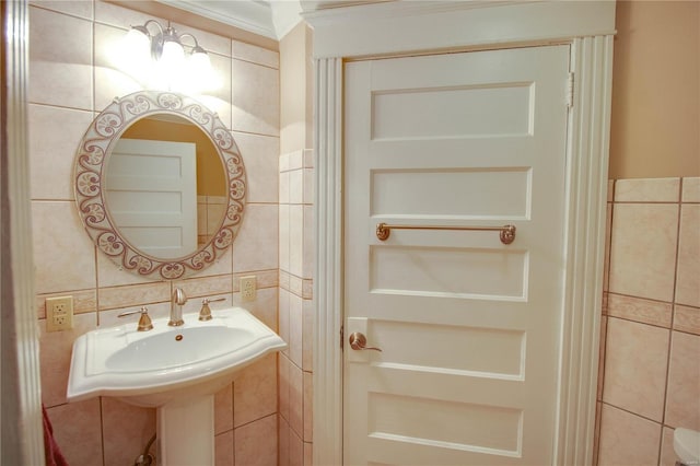 bathroom featuring ornamental molding and tile walls