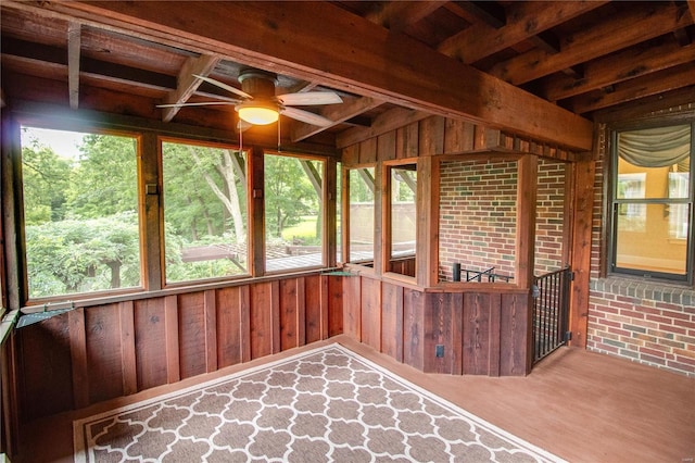 unfurnished sunroom featuring plenty of natural light and ceiling fan