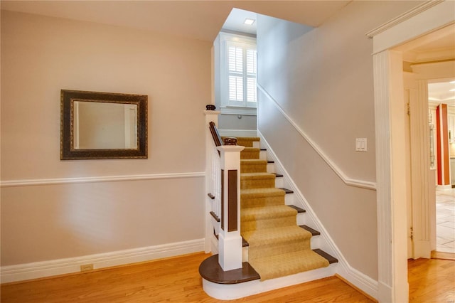 stairs featuring hardwood / wood-style floors