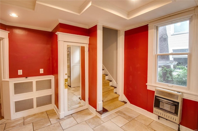 interior space with heating unit, tile patterned flooring, and ornamental molding