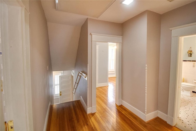 hall with hardwood / wood-style floors