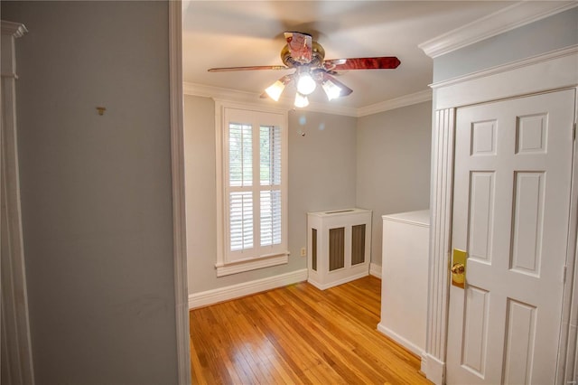 hall with crown molding and light hardwood / wood-style flooring