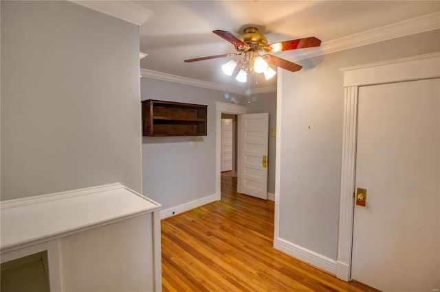 hallway featuring crown molding and light hardwood / wood-style floors