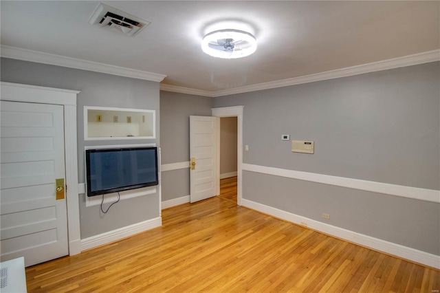 unfurnished living room featuring crown molding and light wood-type flooring