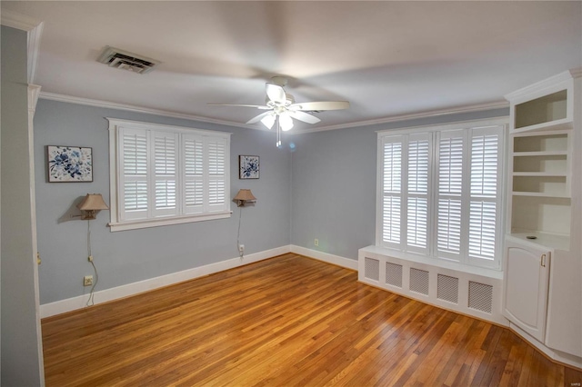 empty room with crown molding, ceiling fan, radiator heating unit, and hardwood / wood-style flooring