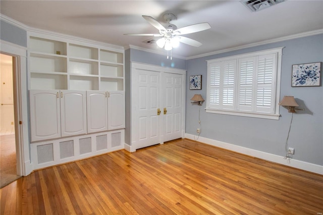 unfurnished bedroom featuring crown molding, ceiling fan, and light wood-type flooring