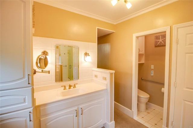 bathroom featuring tile patterned flooring, crown molding, vanity, and toilet