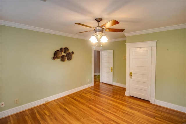 spare room featuring light hardwood / wood-style flooring, ornamental molding, and ceiling fan