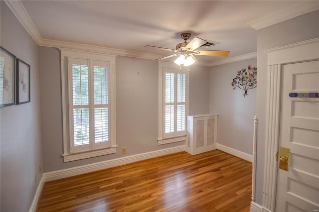 empty room featuring crown molding, ceiling fan, and hardwood / wood-style flooring