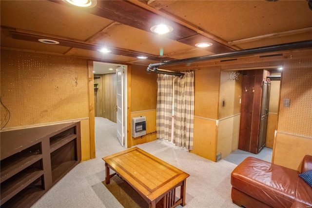 interior space featuring heating unit, light colored carpet, and wood walls