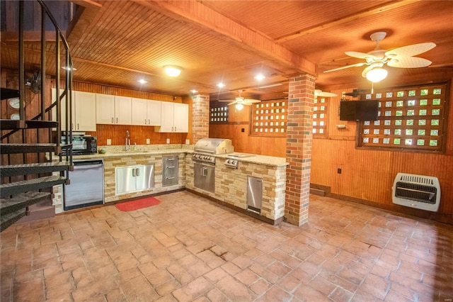 kitchen featuring heating unit, wood ceiling, wooden walls, and dishwasher