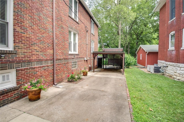 view of side of property with a carport and a yard