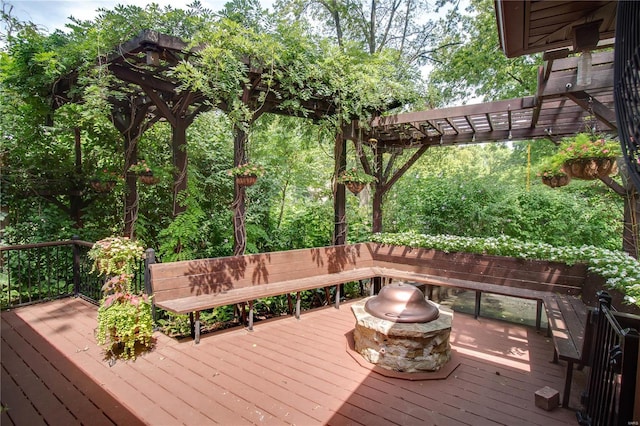 wooden deck with a pergola and a fire pit