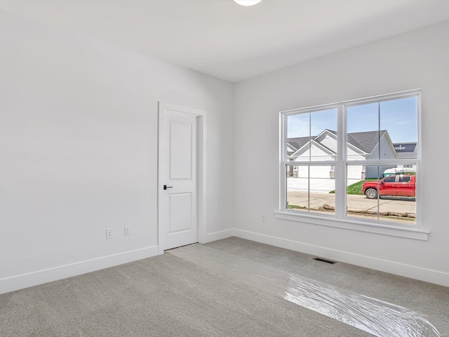 empty room with light colored carpet