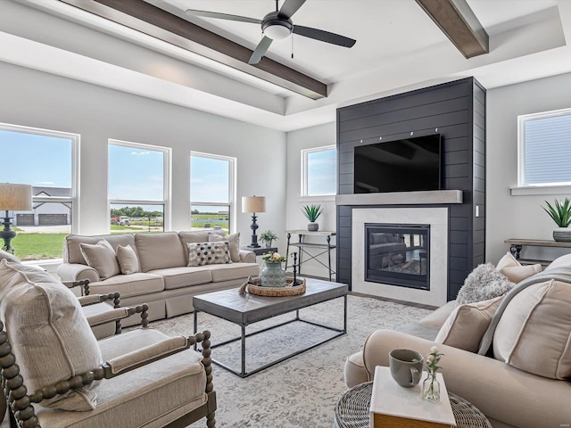 living room with ceiling fan and beam ceiling