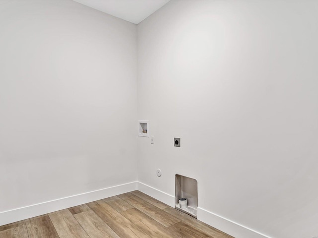 laundry room featuring electric dryer hookup, hookup for a washing machine, and light wood-type flooring