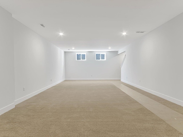 basement featuring light colored carpet