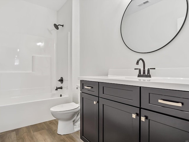 full bathroom with wood-type flooring, toilet, vanity, and  shower combination