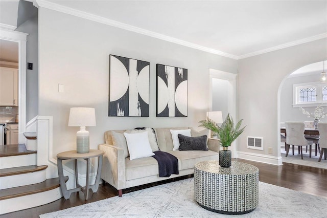 living room with hardwood / wood-style flooring and crown molding