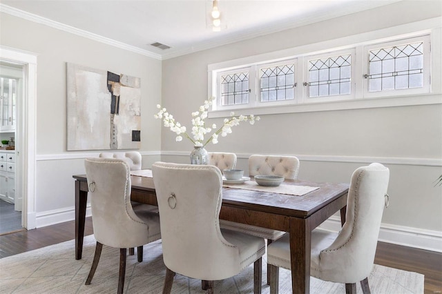 dining room featuring wood-type flooring and crown molding