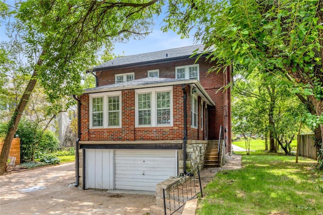 exterior space featuring a garage and a front lawn