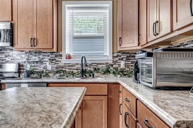 kitchen featuring sink and tasteful backsplash