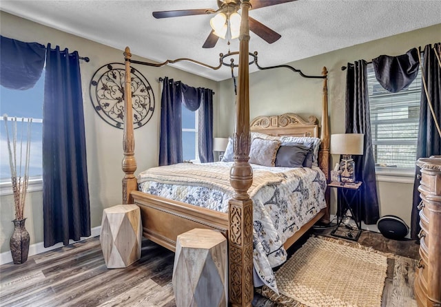 bedroom with wood-type flooring, a textured ceiling, and ceiling fan