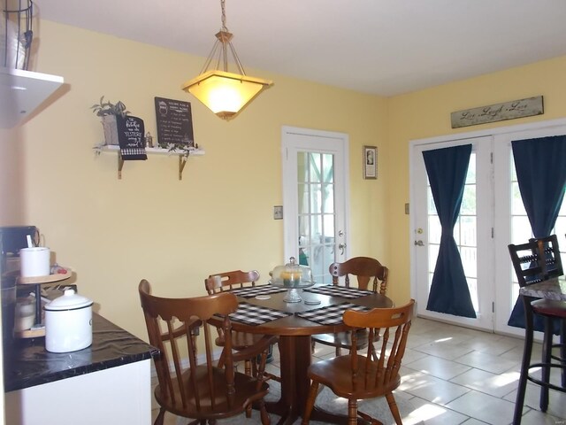 dining space featuring a wealth of natural light, french doors, and tile floors