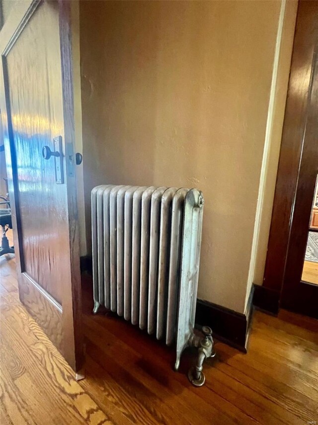 interior space with wood-type flooring and radiator