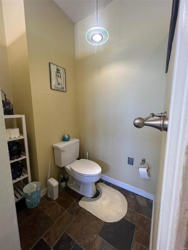 bathroom featuring tile flooring and toilet