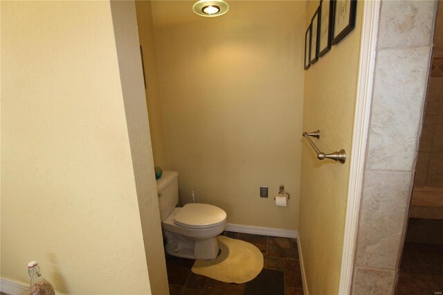 bathroom with tile flooring and toilet