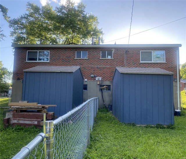 back of house with a lawn