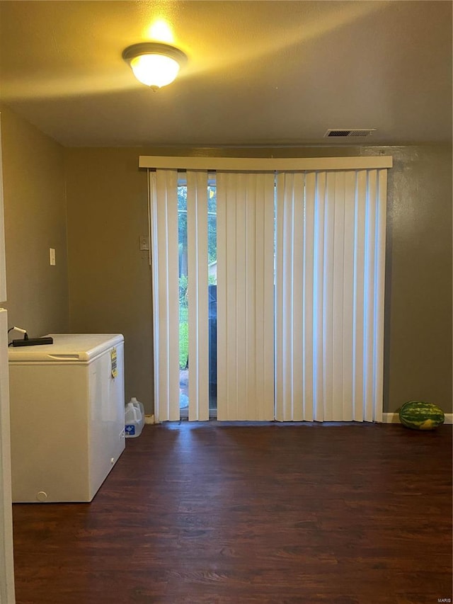 interior space with washer / dryer and dark hardwood / wood-style flooring