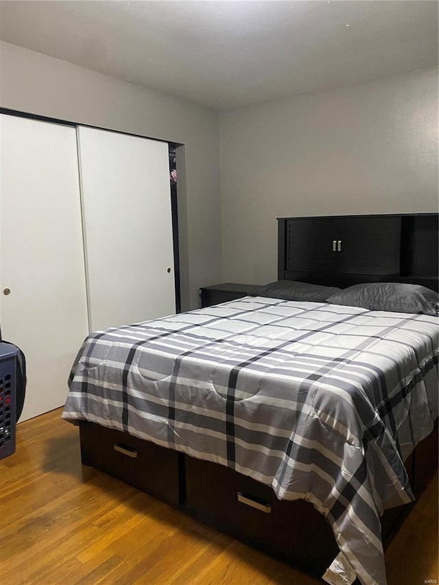 bedroom featuring hardwood / wood-style flooring and a closet