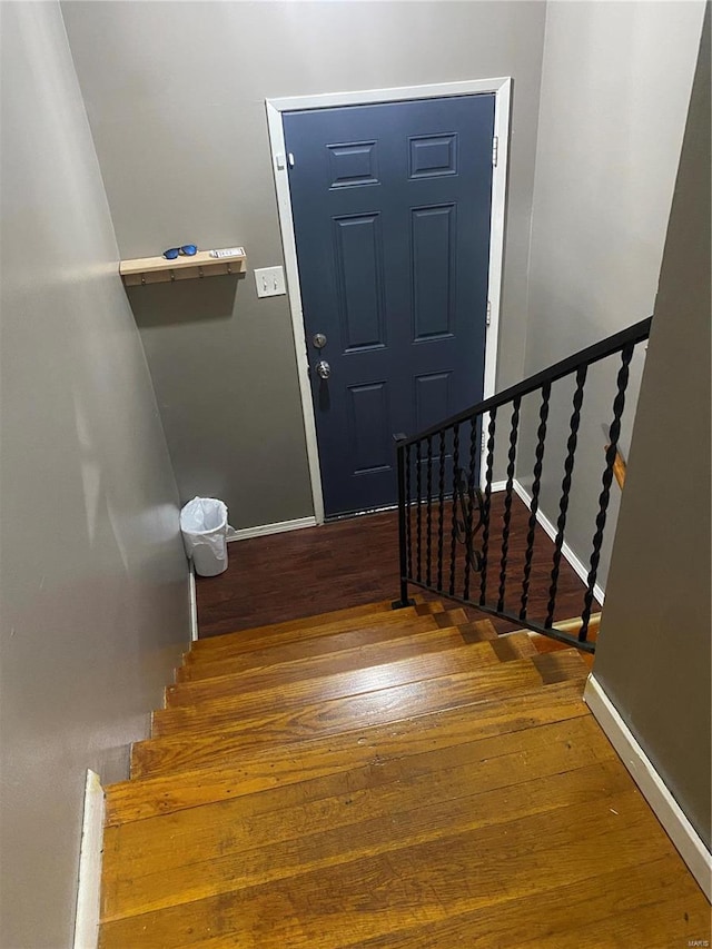 staircase with wood-type flooring