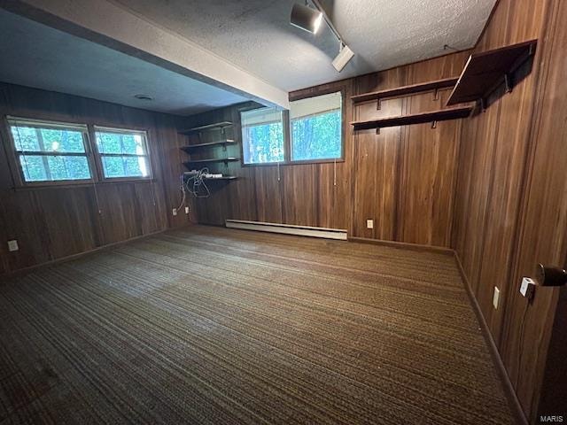 interior space featuring wood walls and a baseboard radiator