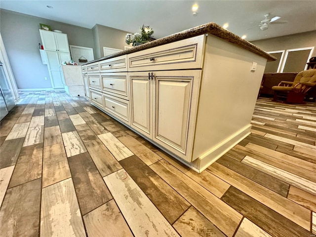 interior space featuring ceiling fan and wood-type flooring